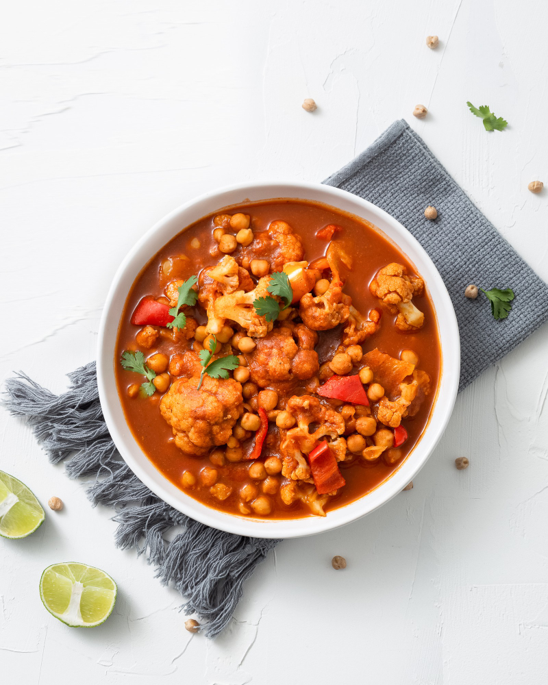 vertical-shot-chickpea-curry-chana-masala-with-lime-bowl-white-surf vertical-shot-chickpea-curry-chana-masala-with-lime-bowl-white-surf